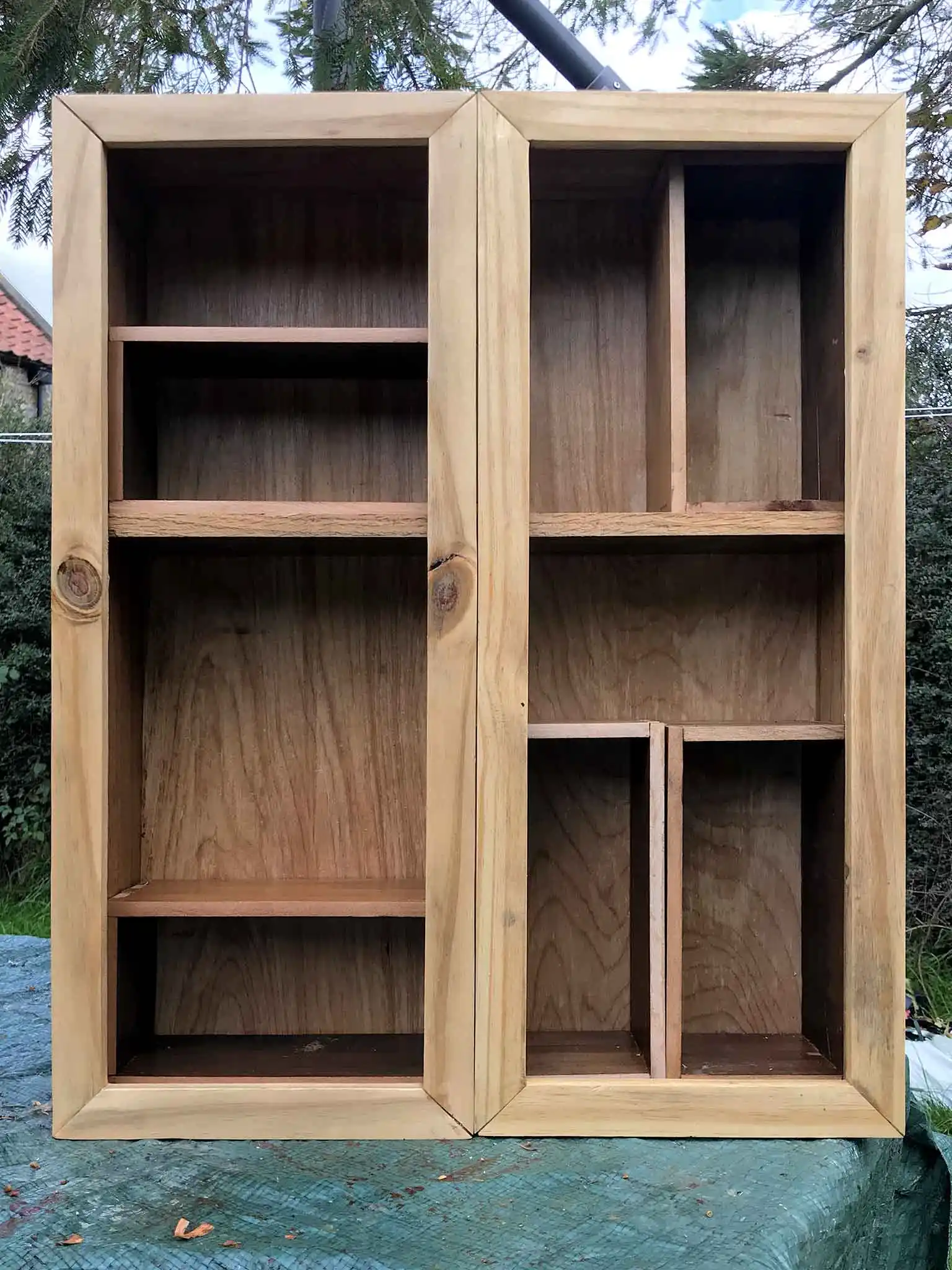 Showing the finished cabinet sat on the garden table.